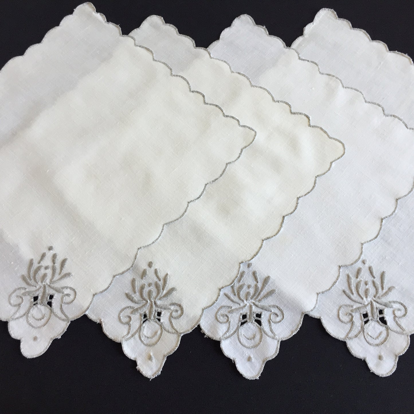 A Set of 4 Madeira Embroidered Cloth Napkins with Scalloped Edging