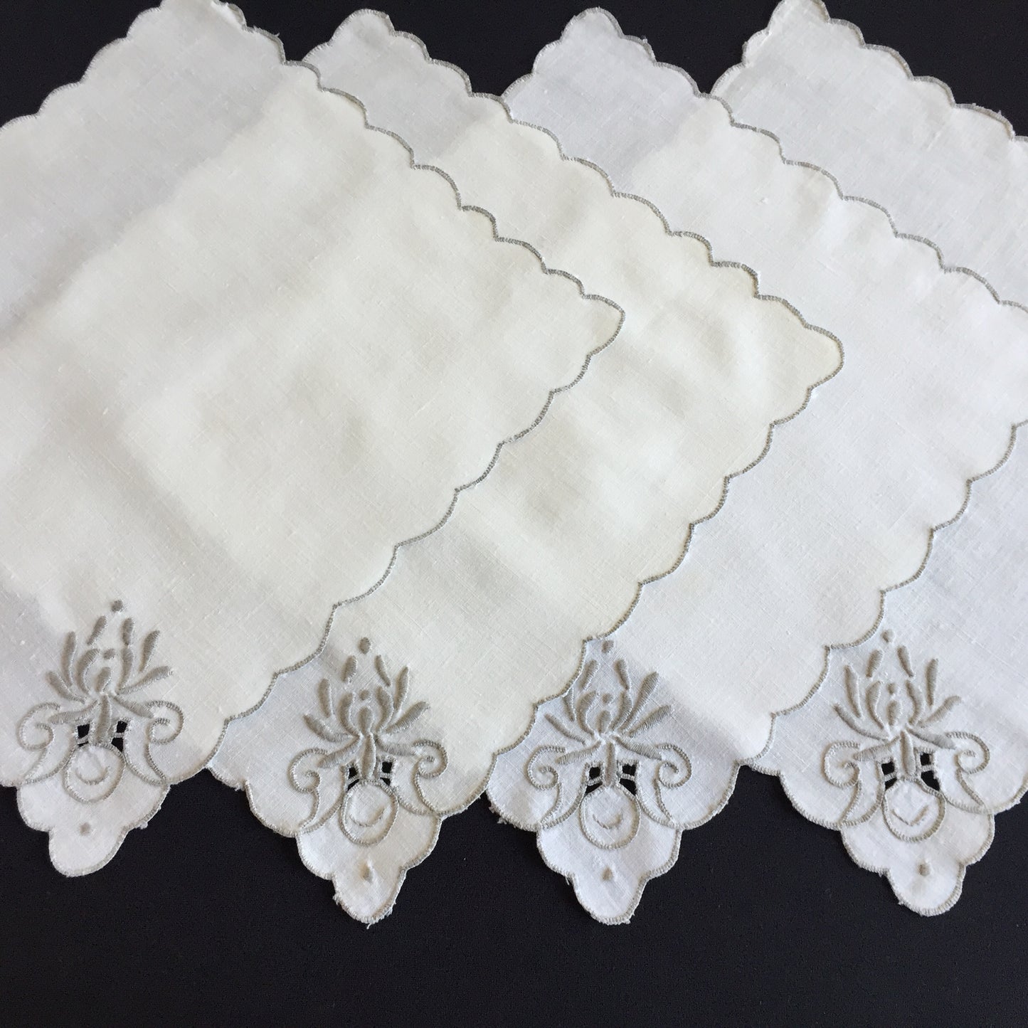 A Set of 4 Madeira Embroidered Cloth Napkins with Scalloped Edging