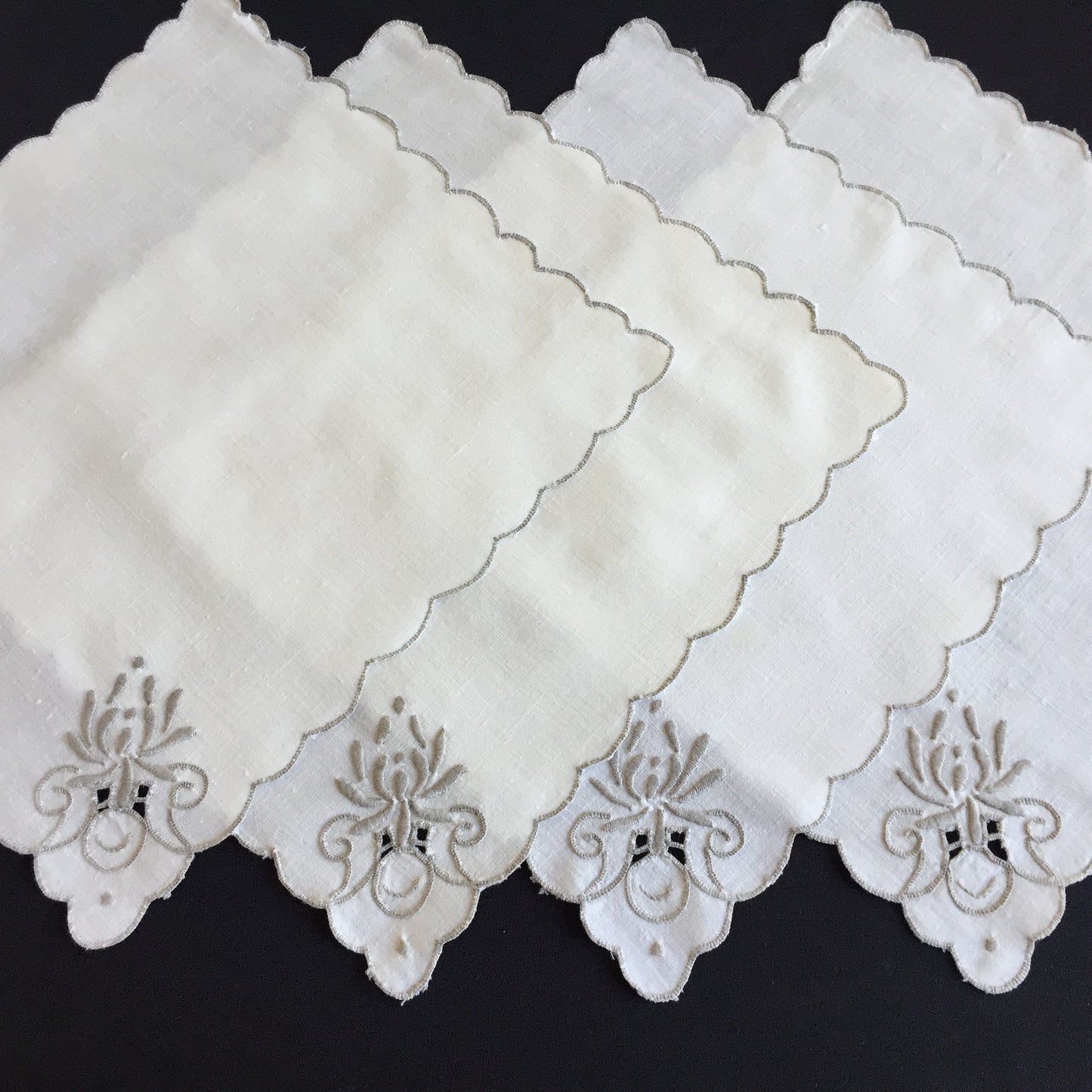 A Set of 4 Madeira Embroidered Cloth Napkins with Scalloped Edging