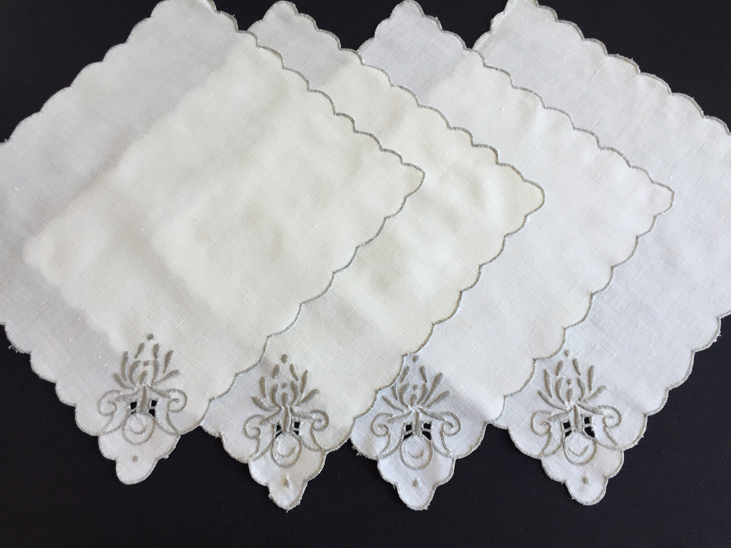 A Set of 4 Madeira Embroidered Cloth Napkins with Scalloped Edging